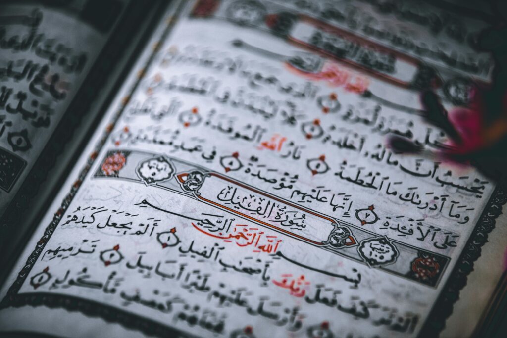 How Many Words Are In The Quran? Detailed close-up of the Quran showing Arabic calligraphy and intricate designs.